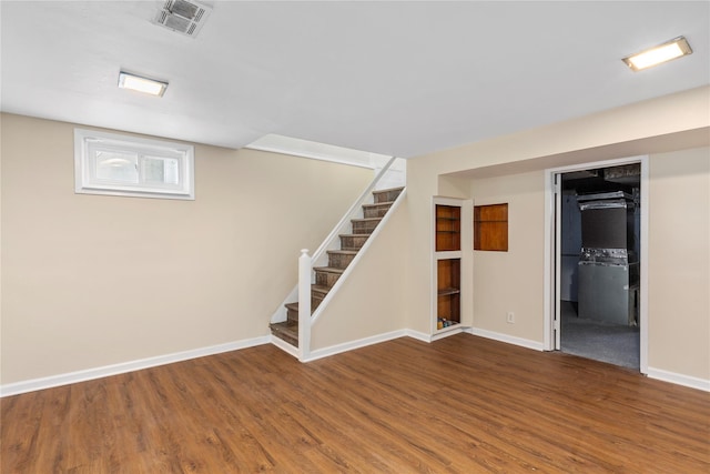 basement with dark hardwood / wood-style flooring