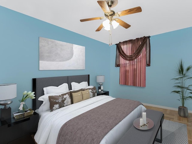 bedroom with ceiling fan and parquet flooring