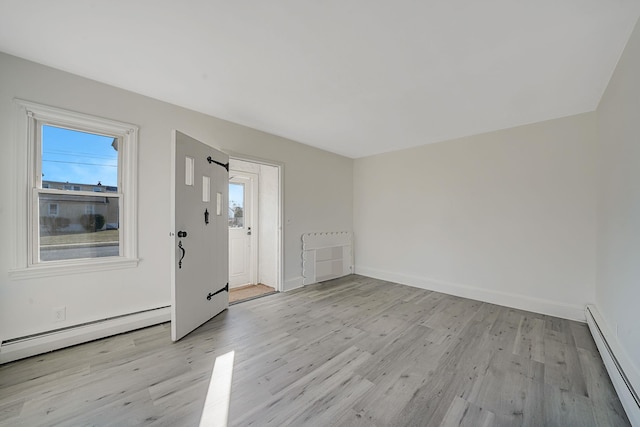 foyer with light hardwood / wood-style flooring and baseboard heating