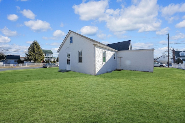 view of property exterior with a yard