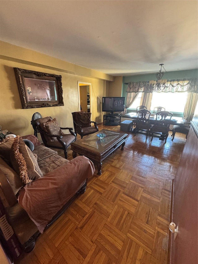 living room with parquet flooring and a chandelier