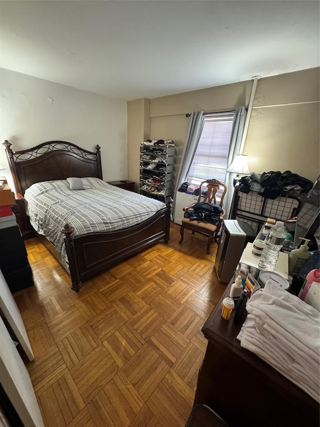 bedroom featuring parquet flooring