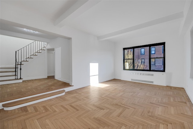 unfurnished living room featuring beamed ceiling, radiator heating unit, and light parquet flooring