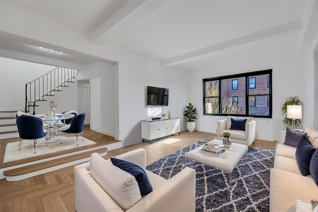 living room with beam ceiling and light parquet flooring