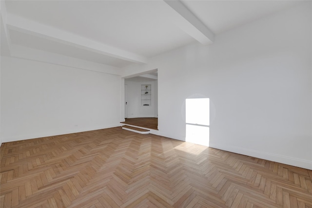 unfurnished room featuring beamed ceiling and light parquet floors