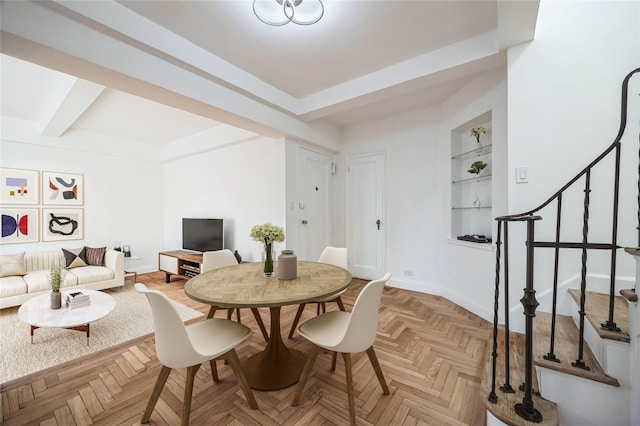 dining area featuring built in features and light parquet flooring