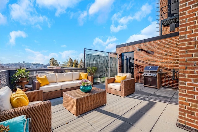 view of patio with outdoor lounge area, a mountain view, and grilling area