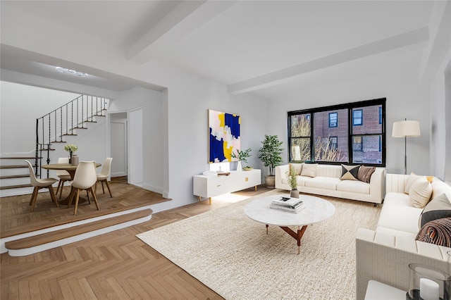 living room featuring beam ceiling and light parquet floors