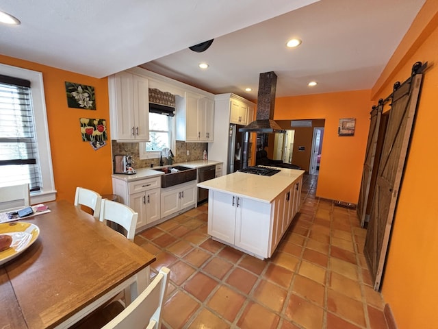 45 Lynbrook Ave, Lynbrook, NY 11563 - kitchen with island range hood, stainless steel appliances, decorative backsplash, white cabinets, and light countertops
