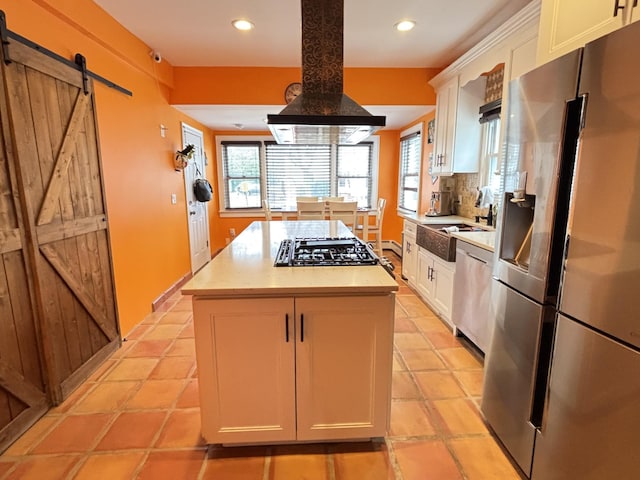 45 Lynbrook Ave, Lynbrook, NY 11563 - kitchen with stainless steel appliances, range hood, light countertops, a center island, and recessed lighting