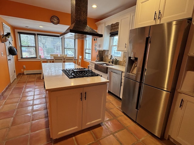 45 Lynbrook Ave, Lynbrook, NY 11563 - kitchen with appliances with stainless steel finishes, island range hood, baseboard heating, a kitchen island, and light countertops