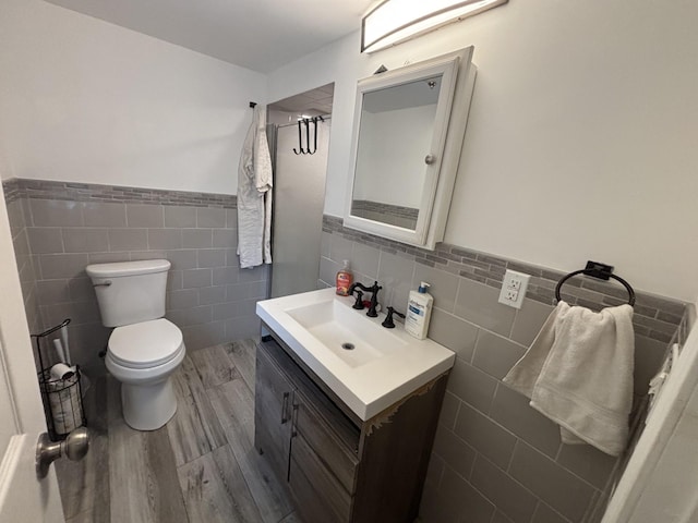 45 Lynbrook Ave, Lynbrook, NY 11563 - bathroom featuring tile walls, vanity, wood finished floors, and wainscoting