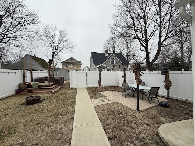 45 Lynbrook Ave, Lynbrook, NY 11563 - fenced backyard with an outdoor fire pit, a patio, and a gate