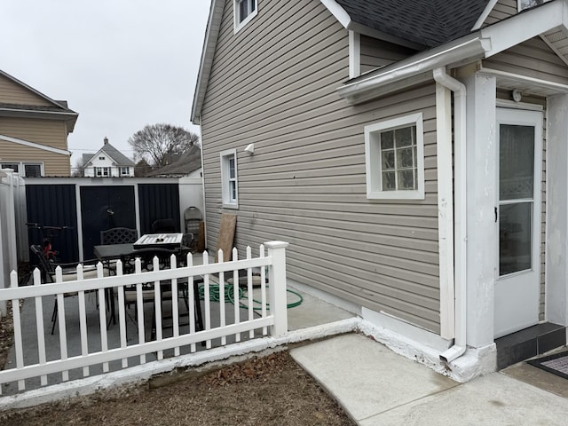 45 Lynbrook Ave, Lynbrook, NY 11563 - view of home's exterior featuring a patio and roof with shingles
