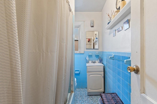 bathroom featuring vanity, tile walls, tile patterned floors, and curtained shower