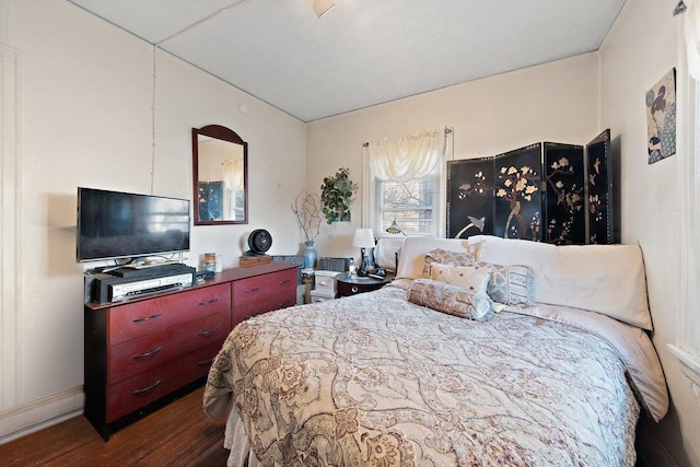 bedroom with dark wood-type flooring