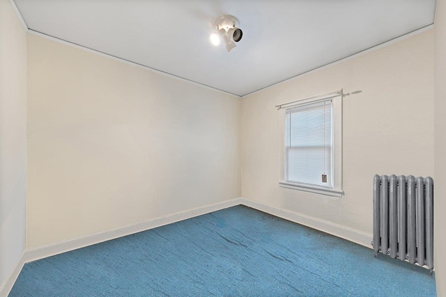 carpeted empty room with radiator heating unit