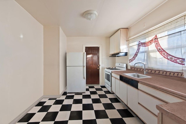 kitchen featuring sink, white appliances, and white cabinets