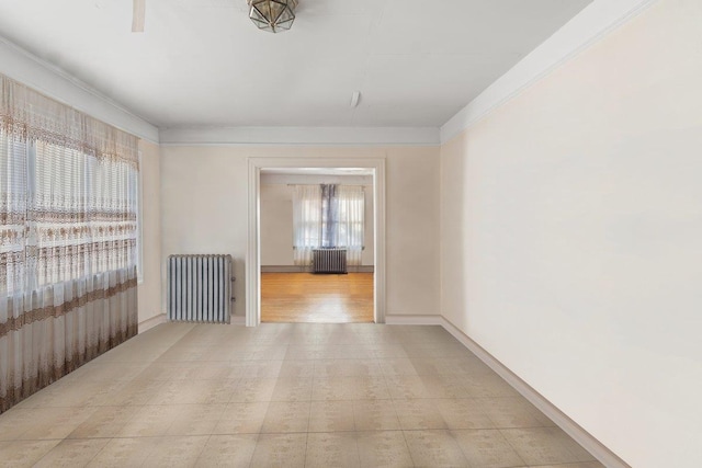 spare room with a healthy amount of sunlight and radiator heating unit