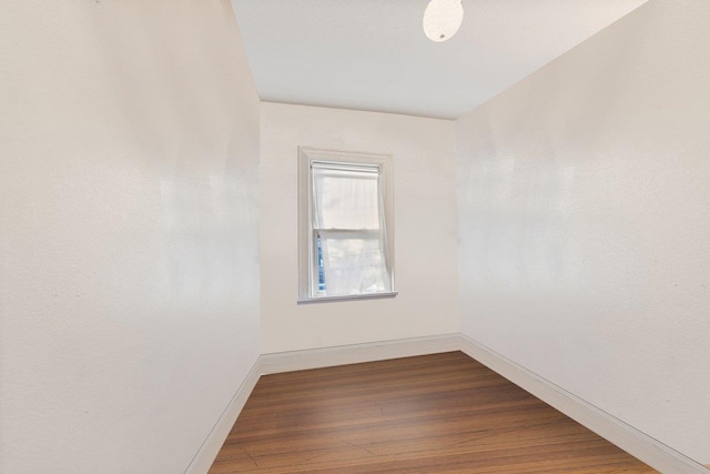 unfurnished room with wood-type flooring