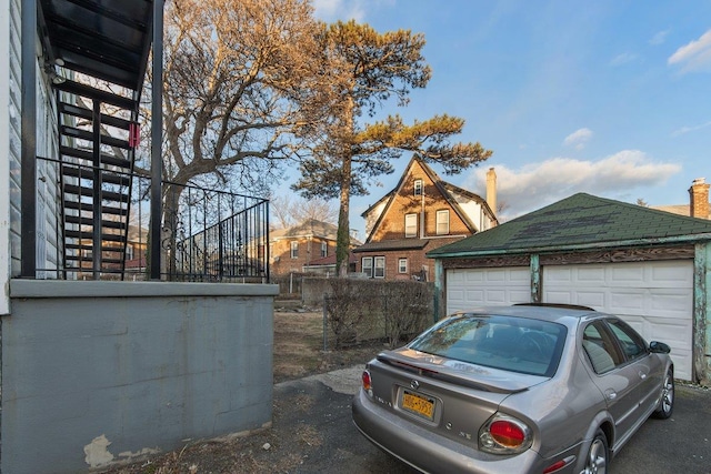 view of property exterior with an outbuilding and a garage