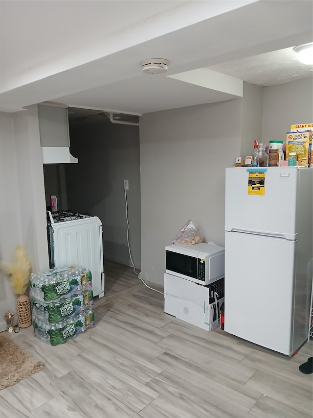 kitchen featuring light hardwood / wood-style floors and white appliances