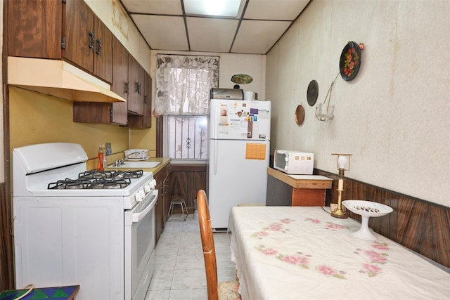 kitchen featuring white appliances, a paneled ceiling, sink, and dark brown cabinetry