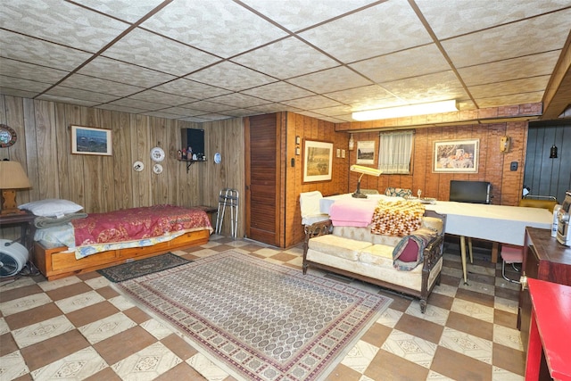 bedroom featuring wooden walls