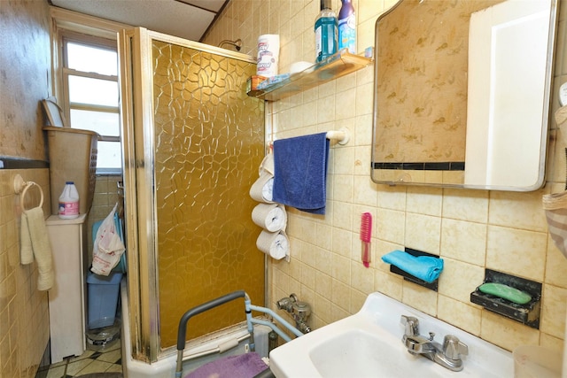 bathroom featuring an enclosed shower and sink