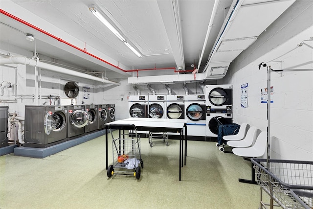 laundry area with washing machine and clothes dryer and stacked washer / drying machine