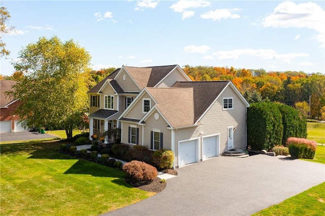 view of front of property featuring a front lawn and a garage