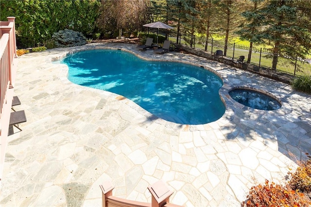 view of swimming pool with an in ground hot tub and a patio