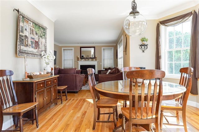 dining area featuring ornamental molding and light wood-type flooring