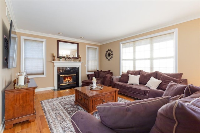 living room with light wood-type flooring and ornamental molding