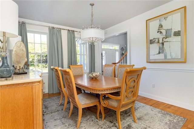 dining area featuring a chandelier, hardwood / wood-style floors, and ornamental molding