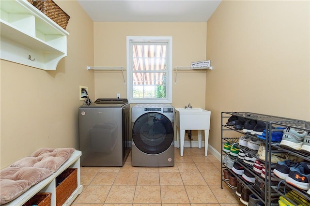 laundry area featuring independent washer and dryer and light tile patterned floors