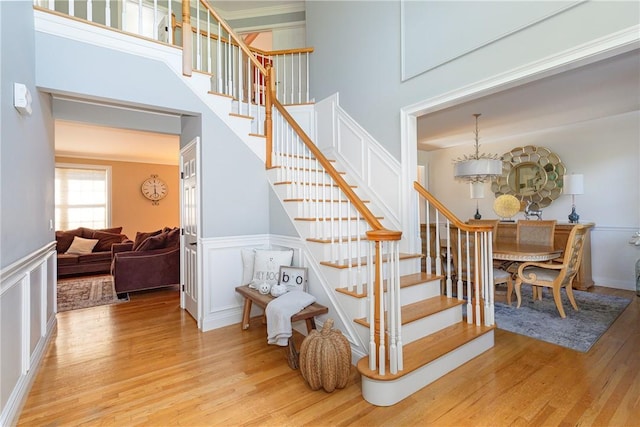 stairway with a chandelier and hardwood / wood-style floors