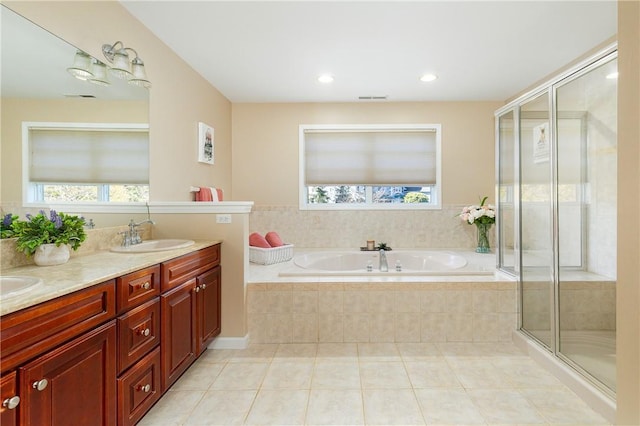 bathroom with tile patterned flooring, shower with separate bathtub, and vanity