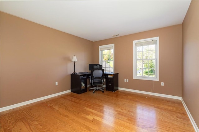 office area with light hardwood / wood-style floors