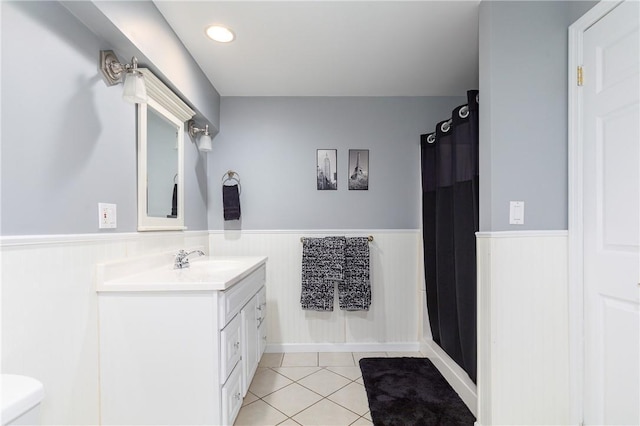 bathroom with tile patterned floors, vanity, and curtained shower