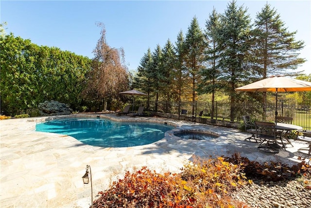 view of swimming pool featuring an in ground hot tub and a patio area