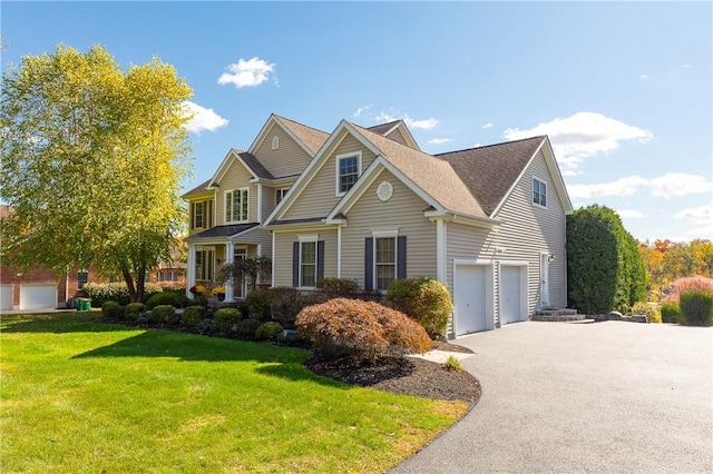 view of front of property with a front yard and a garage