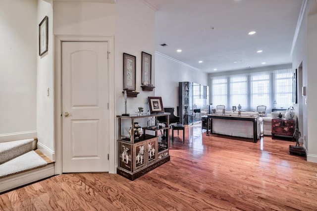 interior space with hardwood / wood-style floors and ornamental molding