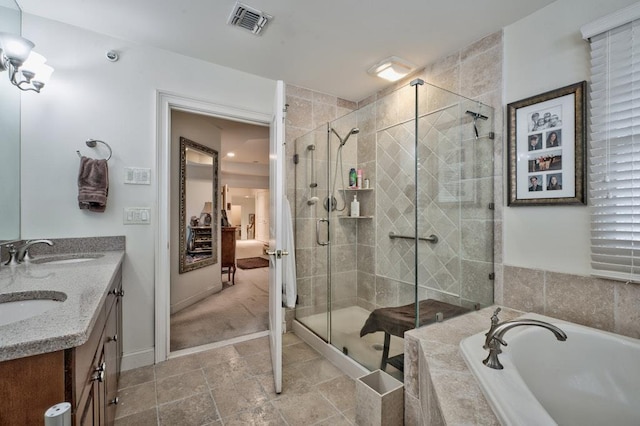 bathroom featuring vanity and separate shower and tub