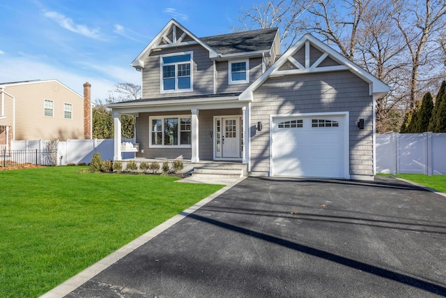 craftsman house with a porch, a garage, and a front lawn