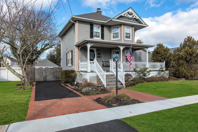 victorian-style house with a porch and a front yard