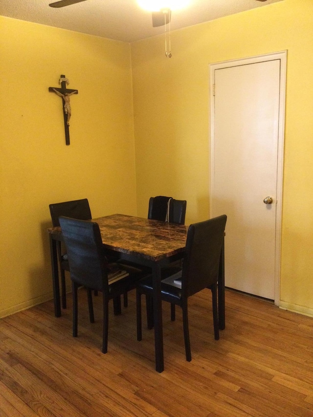 dining room featuring hardwood / wood-style floors and ceiling fan