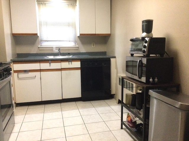 kitchen with white cabinetry, appliances with stainless steel finishes, sink, and light tile patterned floors