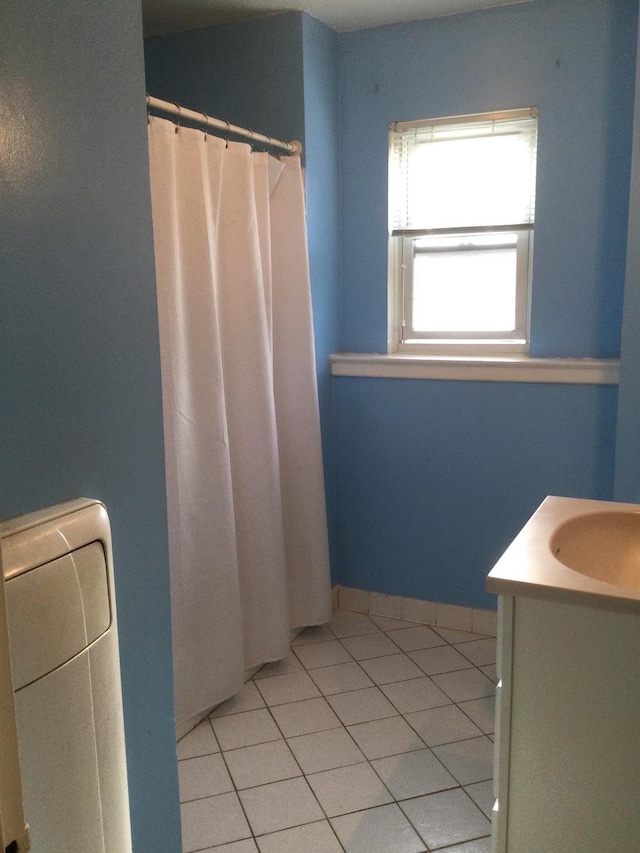 bathroom with tile patterned flooring and vanity