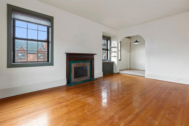 unfurnished living room with wood-type flooring